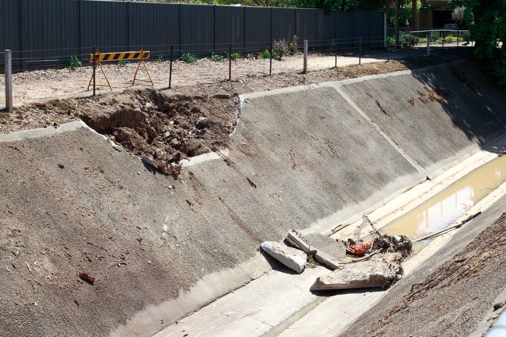 Break away: Concrete slabs rest on the bed of Bungambrawatha Creek after a tree was uprooted at the direction of Albury Council. Picture: SIMON BAYLISS 