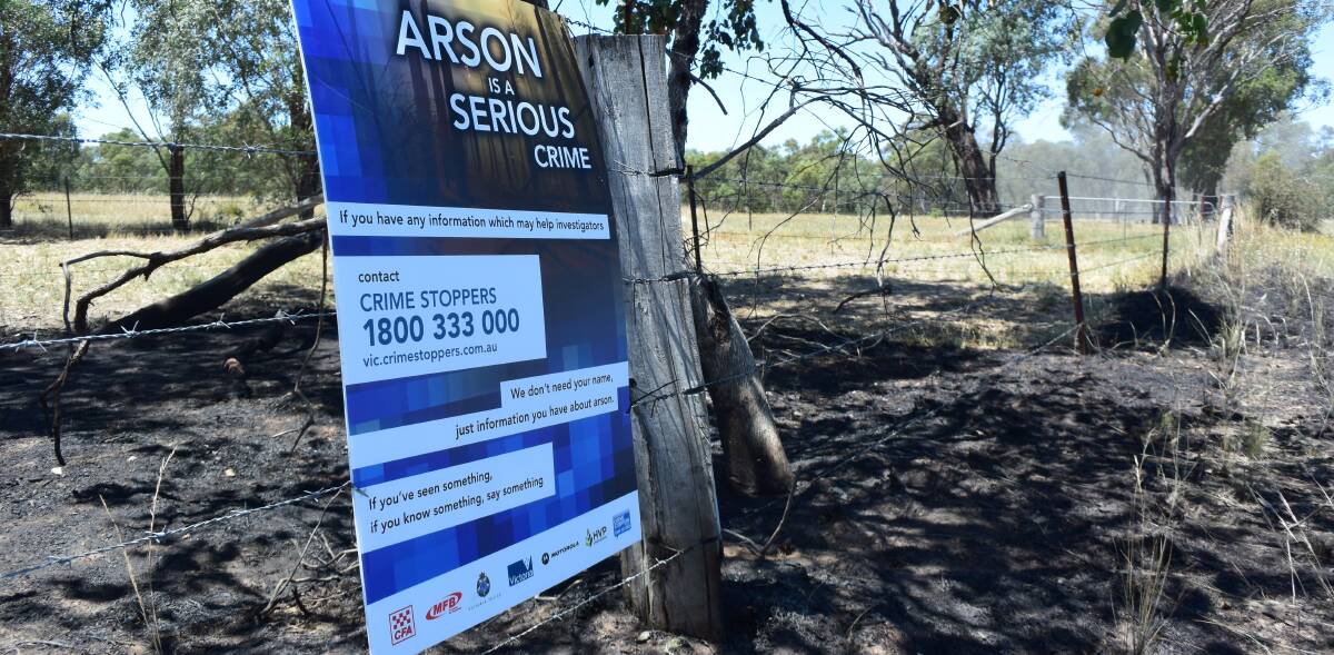 Help wanted: A poster displayed at Haynes Road after a suspicious fire. It was one of two incidents along the dirt strip of roadway at Browns Plains. 