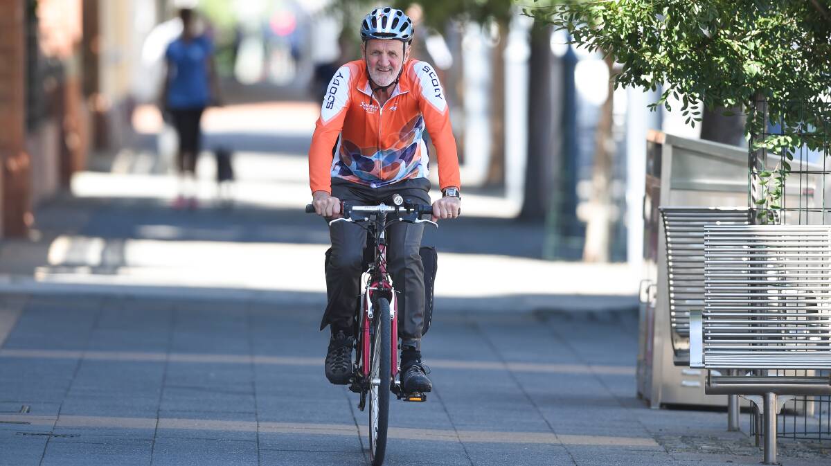 Two -wheeled trekker: Albury councillor David Thurley has swapped his car for a bike this week as part of an experiment in transport. He is pictured in Kiewa Street. Picture: MARK JESSER
