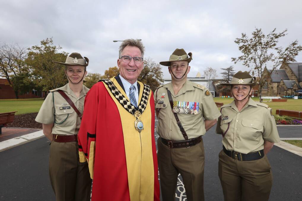 Ceremonial occasion: Albury mayor Kevin Mack with the army's Major Jess Barker, Lieutenant Colonel Pete Fleming and Private Debra Kaindl following Saturday's parade. Picture: JAMES WILTSHIRE