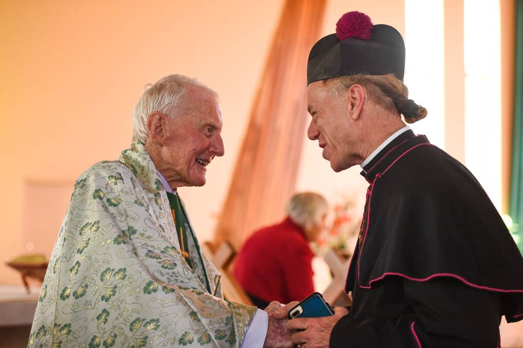 Across the divide: Father Flanagan with Anglican priest Peter MacLeod-Miller directly after the service.