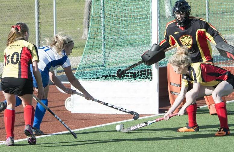 DOWN TO THE LINE:  Janessa Leggatt is swamped as she attacks for Norths in women's first grade hockey action. Leggatt scored two in the win over United.