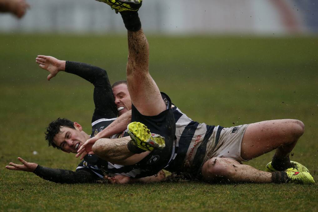 MAGPIE APPEAL: Wangaratta's Josh Owen looks hopeful of a free kick as Yarrawonga's Wade Lees takes him down at a rain-soaked Norm Minns Oval on Saturday.  Picture: MARK JESSER