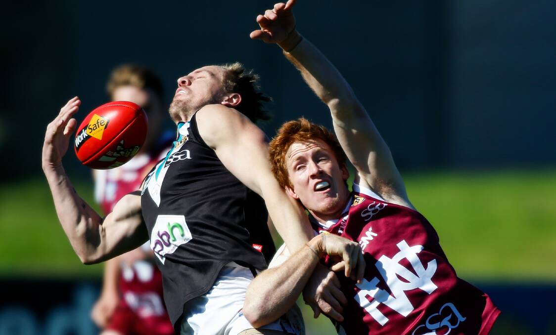HANDS FULL: Lavington's Adam Prior attempts a one-handed mark against Wodonga's Zach Jones on Saturday. Picture: MARK JESSER