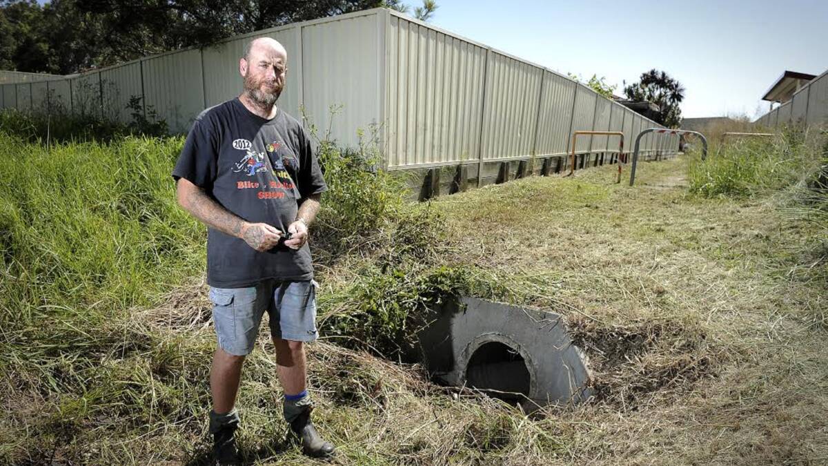 LONELY SCENE: Dave Pettit was mowing the laneway next to his Rutherford house when he came across the body of Dean Shield lying next to the drain. Picture: Perry Duffin.