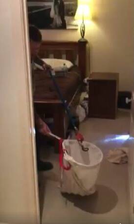 SAFE: Tristan Hamilton catches the snake in Natalie and James Nelson's bedroom. Photo via Facebook