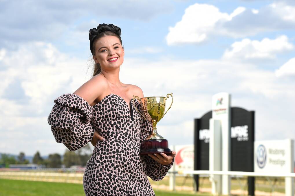 IT'S CUP DAY: Tilly Morris, 18, with the Wodonga Gold Cup. Tilly will be trackside today and has ridden horses for 12 years. Photo: MARK JESSER