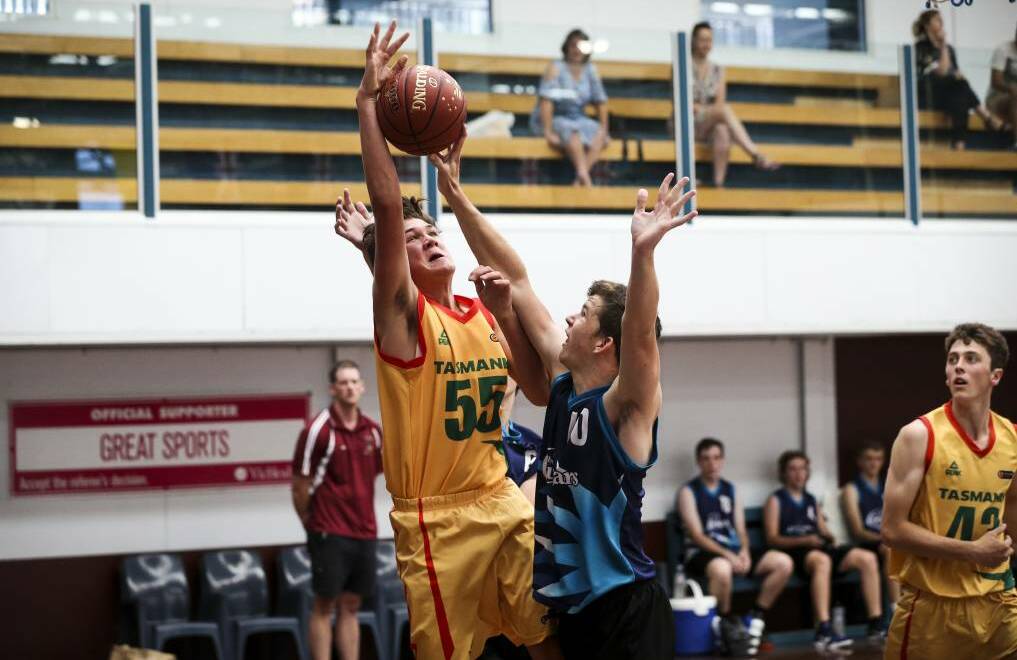 Albury-Wodonga's Blake Mills attempts to block Tasmania's Hayden Zasadny's shot for basket. Day 2 of the Australian Junior Country Basketball Cup. Photo: James Wiltshire.