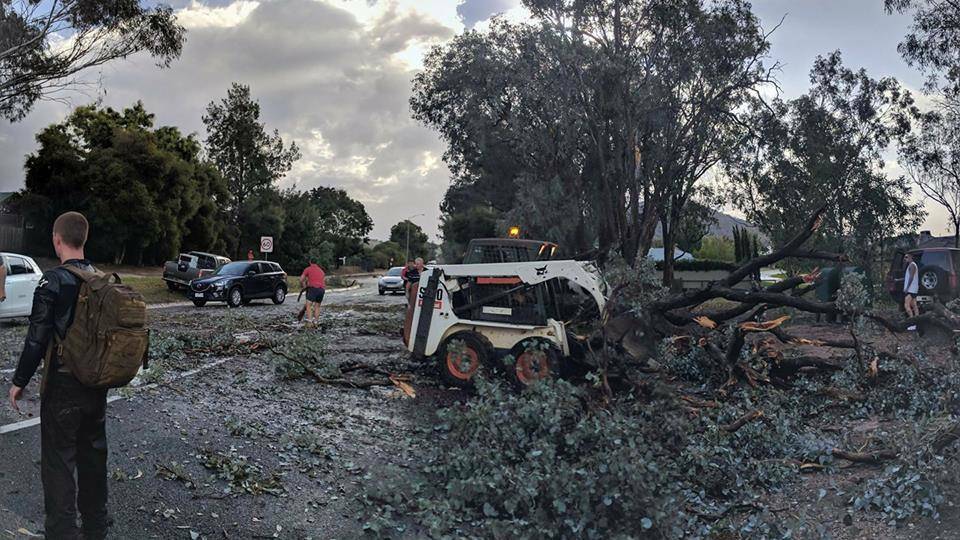Community spirit: The clean up begins after the wild storm lashed Wodonga late Monday. 