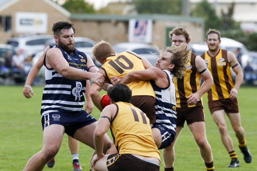 HAIR-RAISING: Rutherglen's John Spencer (left) and Dylan Simpson tackle the Hawks' Caleb Beattie. The Hawks won by 19 points.
