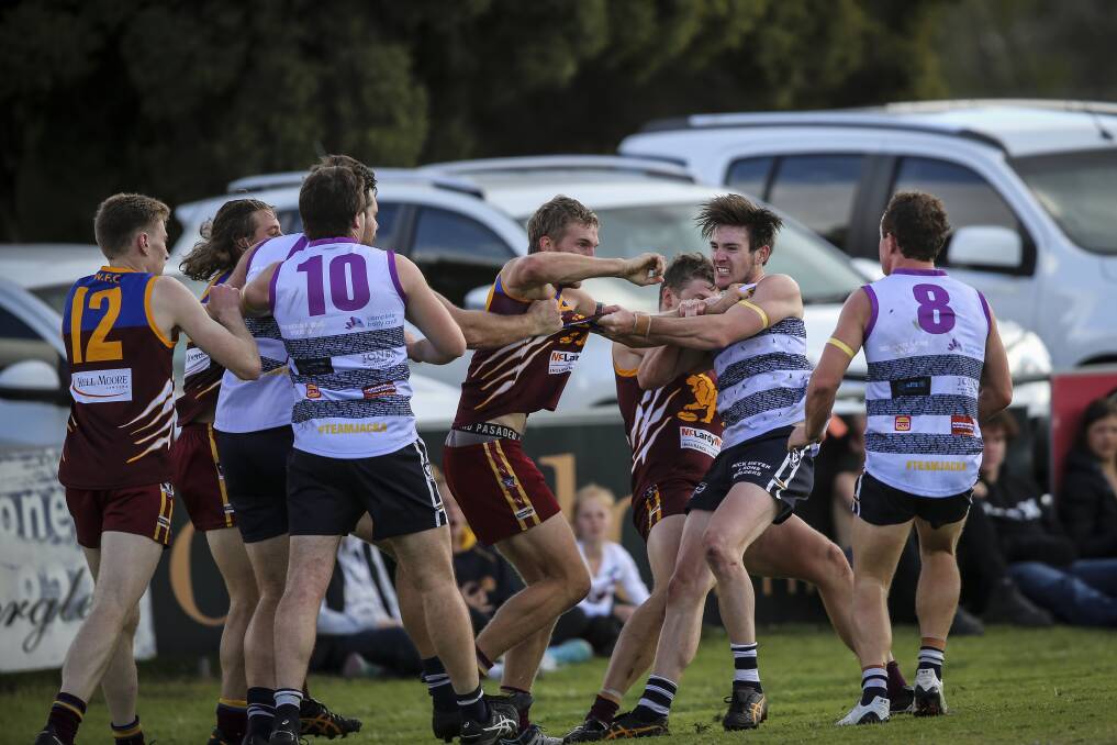 RUGGED RUTHERGLEN: Tyson Neander (right) battles his Wahgunyah opponents during the clash on Saturday. Neander kicked three goals in the upset win.