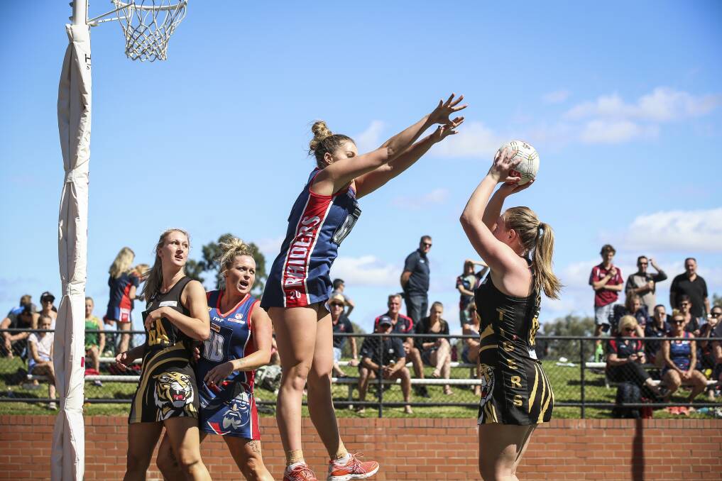 Wodonga Raiders' Brooke Pryse tries her best to stop Albury's Claire Wilson. The Tigers' attacking spearhead grabbed 29 goals in the 49-32 win.