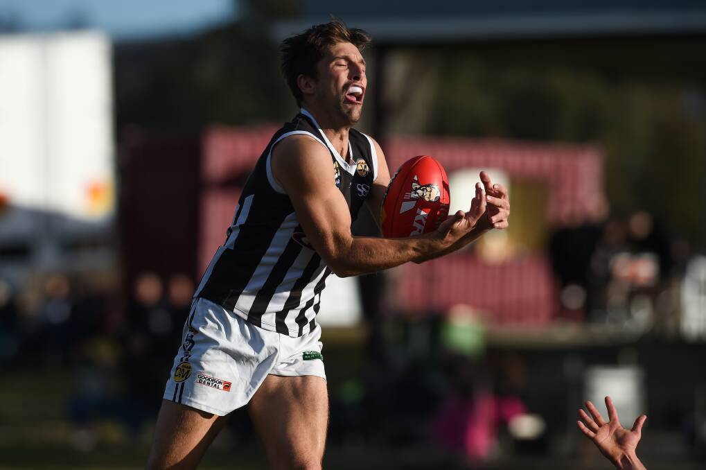 DOUTHIE'S DESIRE: Underrated Pies' defender Ben Douthie takes a mark against Wodonga. Douthie is a clever player with a neat clearing kick.