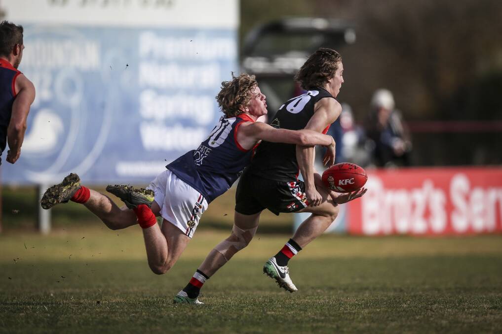 TENACIOUS TEENAGER: Wodonga Raiders' Dylan Clarke chases down the Saints' Will Quirk. Picture: JAMES WILTSHIRE