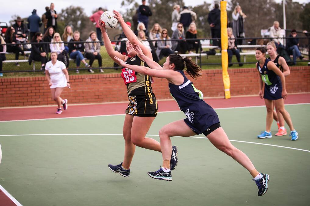 DESPERATE TIMES: Yarrawonga's Annalise Grinter tries her best to stop Albury's Claire Wilson. Grinter moved from goal defence to goal keeper after Hannah Symes pulled out. Picture: JAMES WILTSHIRE