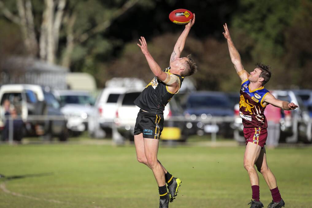 HANDS UP: The Tigers' Matt McLinden tries to mark the ball, ahead of Wahgunyah's Dylan Cook. The Lions won by 16 points.