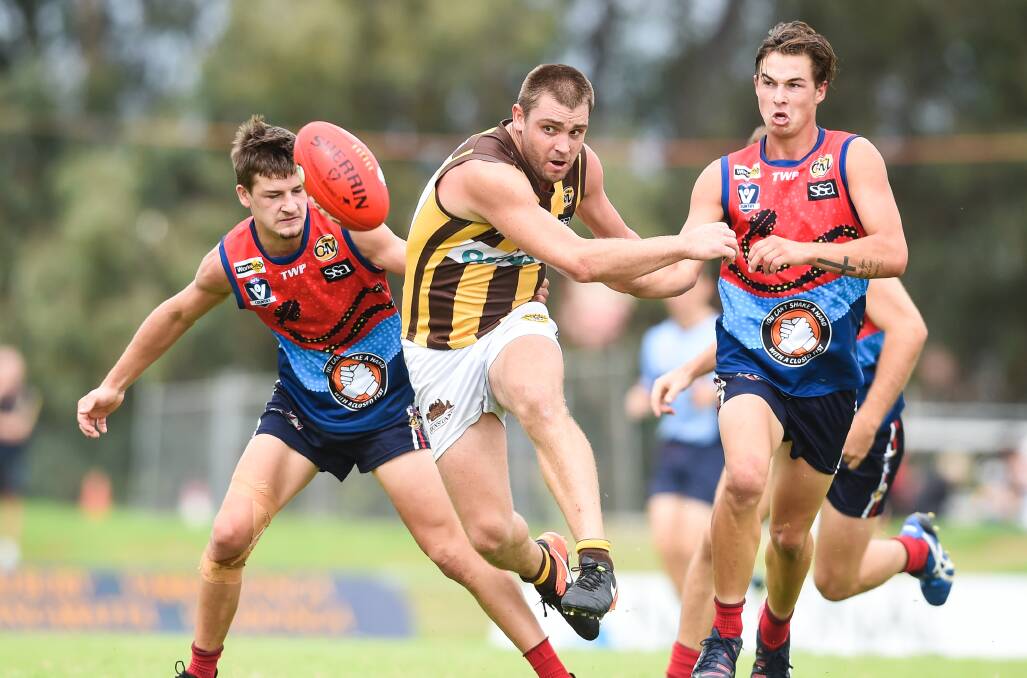 HAWK HOUNDED: Wangaratta Rovers' Sam Carpenter has Raiders' Ethan Boxall (left) and Raven Jolliffe in pursuit. Picture: MARK JESSER