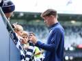 Connor O'Sullivan signs autographs on his debut day. Picture by Brad McGee Geelong Cats