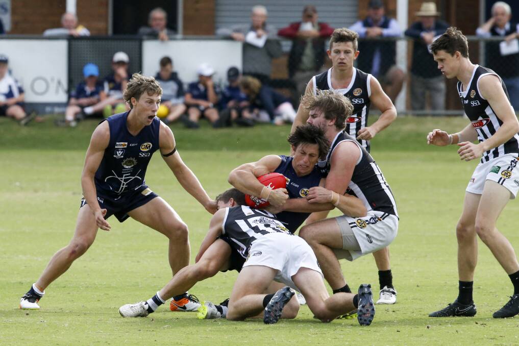 DOUBLE-TEAMED: Yarrawonga's Tyler Bonat is tackled by Wangaratta's  Daniel Sharrock (left)  and Zac Leitch at the JC Lowe Oval.