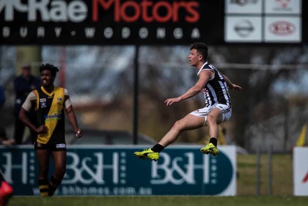 JUMPING JESSIE: The Pies' Jessie Smith lands a 50-metre goal in the first quarter against Albury. Smith's effort handed his team an eight-point lead.