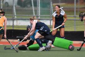 Spitfires' goalkeeper Georgia Martin makes a spectacular save. Picture by Hockey Albury Wodonga