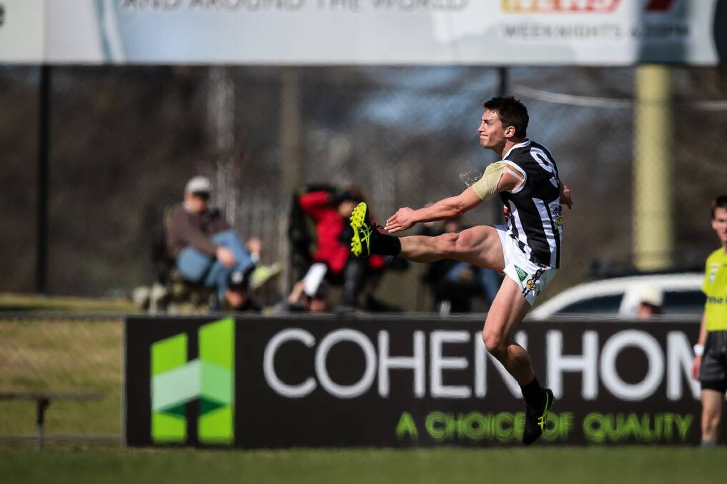 FLYING HIGH: Wangaratta's Ben Speight kicks for goal against Albury in the second semi. Speight kicked two goals in the seven-point loss.