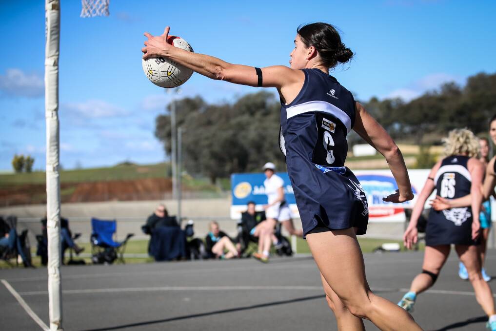BACK OF BOURKE: The Pigeons' Laura Bourke attempts to keep the ball in play during her team's five-goal loss. Bourke was one of the Pigeons' best.