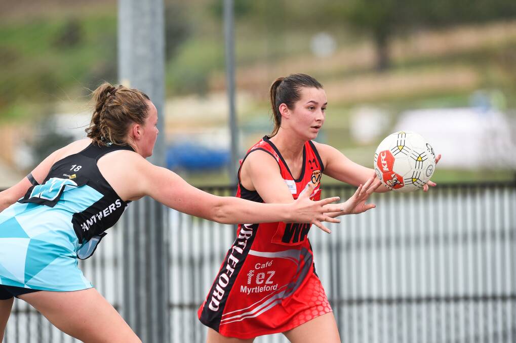  TIGHT DEFENCE: Myrtleford's Sally Botter passes the ball in her team's 54-26 loss to Lavington. The Panthers remain undefeated after four rounds.