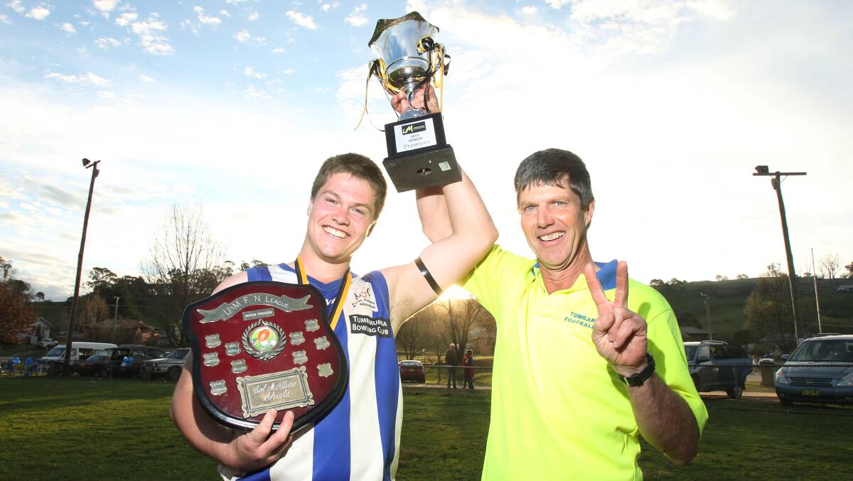 Jim and Mont Waters with the premiership cup after the Roos' 2013 grand final victory.