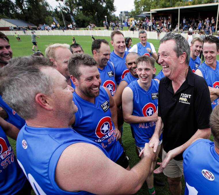 GOOD SPIRITS: Neale Daniher congratulates some of the All Star players after more than $70,000 was raised to fight MND. Picture: JAMES WILTSHIRE