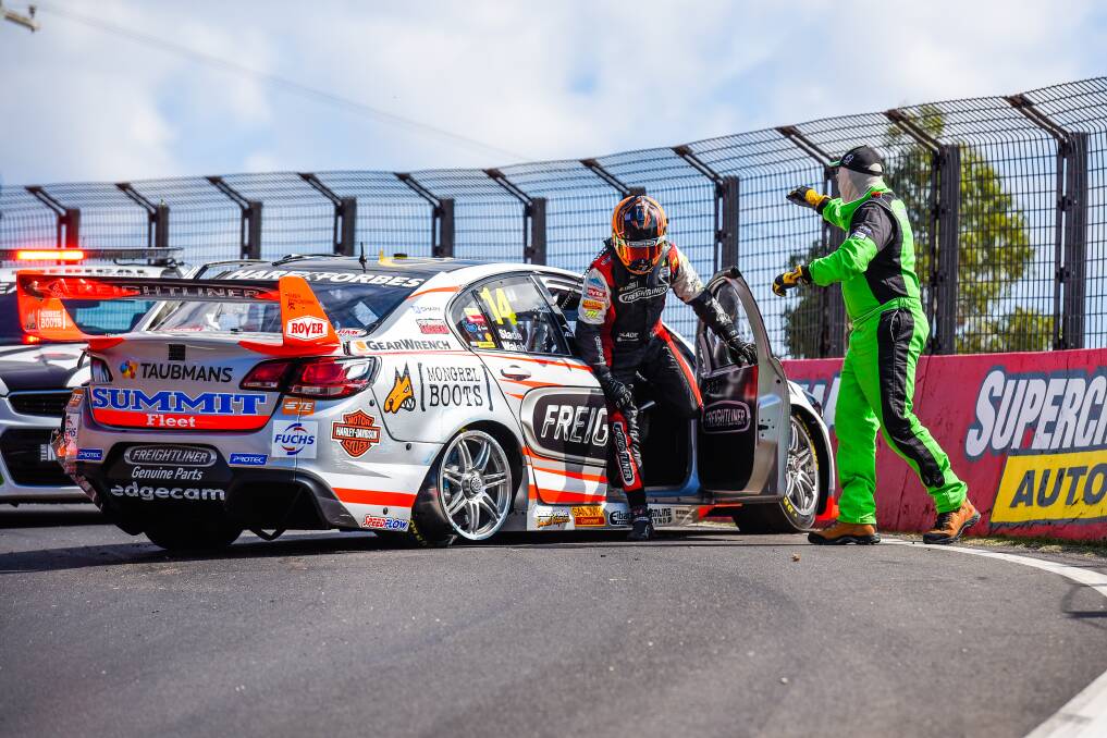 DAY DONE: Brad Jones Racing's Tim Slade make his way out of his vehicle after sustaining major damage in the first practice session of the Bathurst 1000.