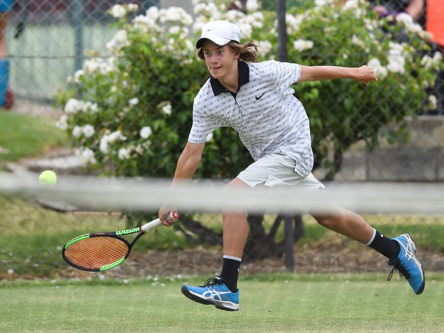 CHASE DOWN: Dan Smith hits top gear to reach a short return at the Albury grass courts on Sunday during his singles match at the Margaret Court Cup.