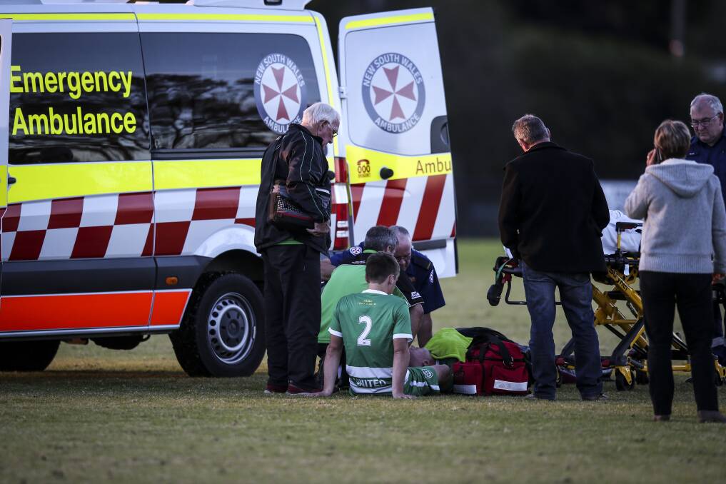 HUGE CONCERN: Albury United's Ben Hughes and Kris Wheeler prepare to be taken away in an ambulance after a huge clash of heads at Glen Park on Sunday. Picture: JAMES WILTSHIRE
