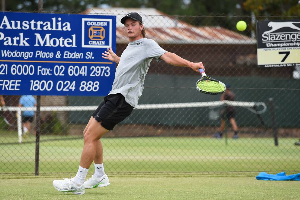 STRONG RETURN: Blake Bayldon expertly guides the ball back into play at full stretch during Sunday's action at the Margaret Court Cup in Albury: Pictures: MARK JESSER