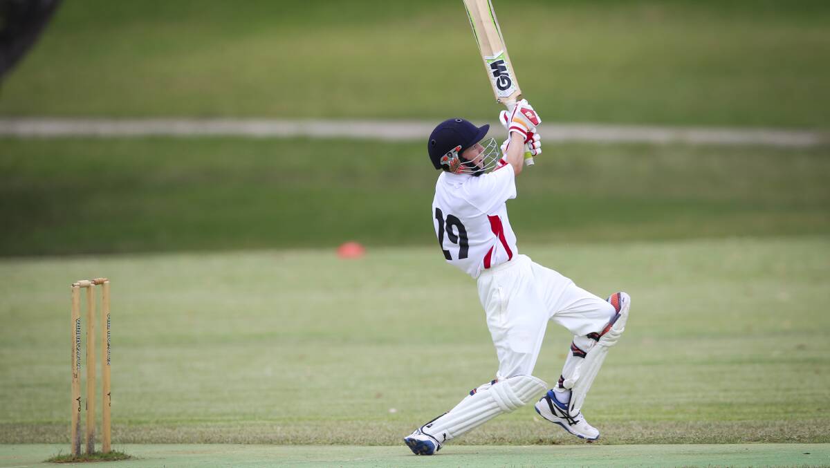 HITTING OUT: Paddy Parnell hits out in his innings of 44 for CAW Country against CAW. Picture: JAMES WILTSHIRE