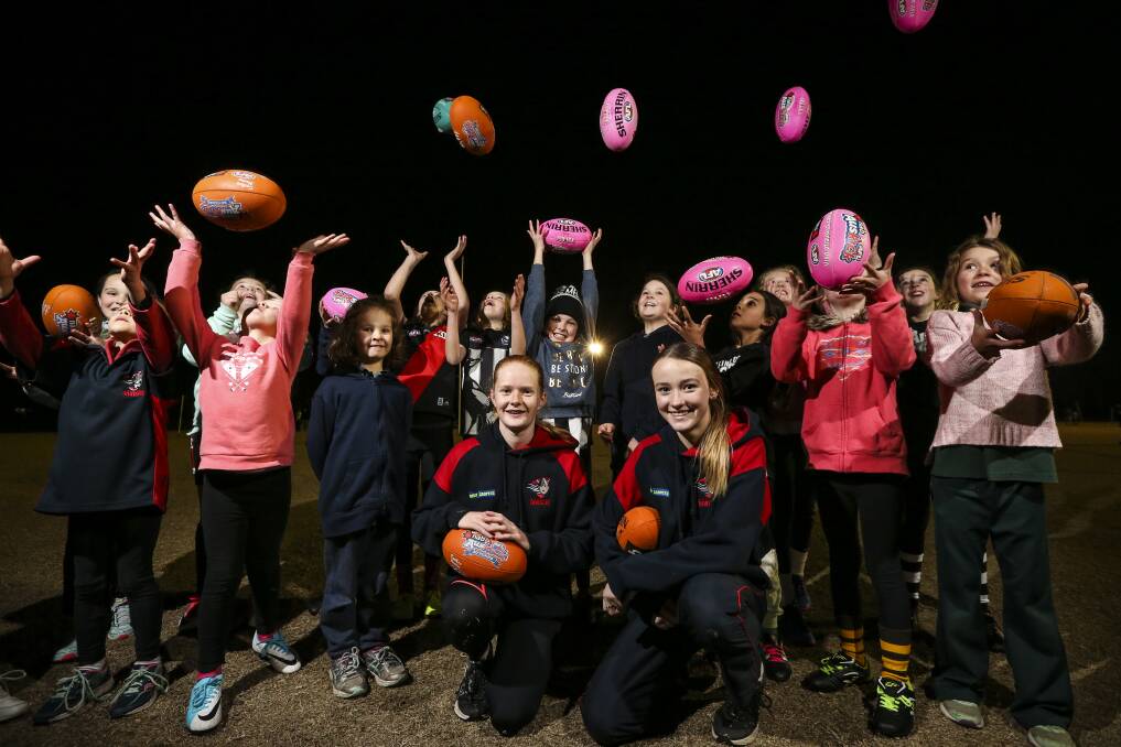 GENERATION NEXT: Wodonga Raiders' Youth Girls stars Chelsea Styan and Elyse Crimmins have been working with the Baranduda Auskick girls to teach them the skills of football. Picture: JAMES WILTSHIRE