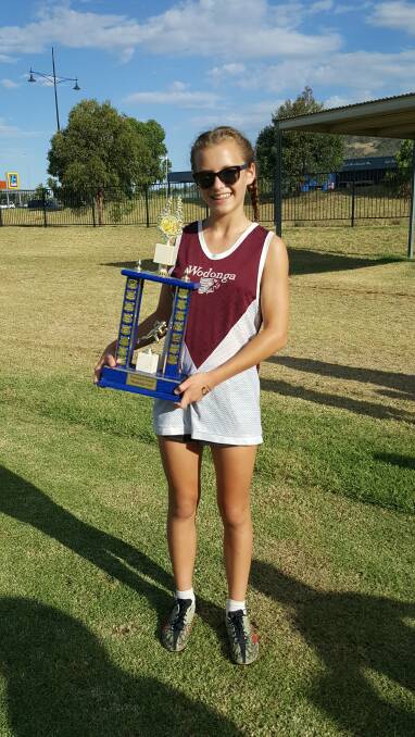 PROUD MOMENT: Clio Knight shows off the silverware after winning the Veronica Foard Gift at Wodonga Athletics Club.