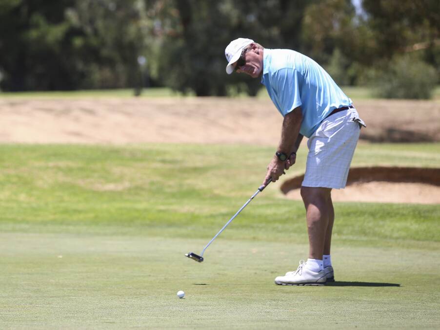 FOOTBALL IDENTITY: Two-time VFL Brownlow Medallist Peter Moore eyes off a long putt at Corowa Golf Club on Saturday.