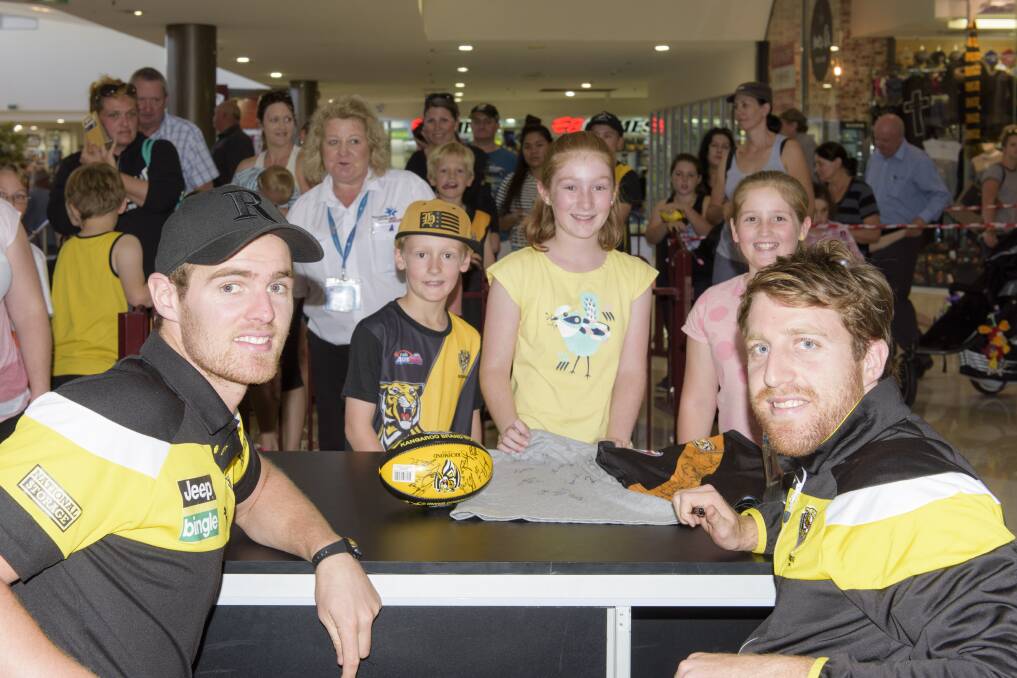 TIGERS IN TOWN: Richmond's David Astbury and Reece Conca meet Wodonga's Sahara (11), Macey (10) and Cohen (8) Thorp. Picture: SIMON BAYLISS