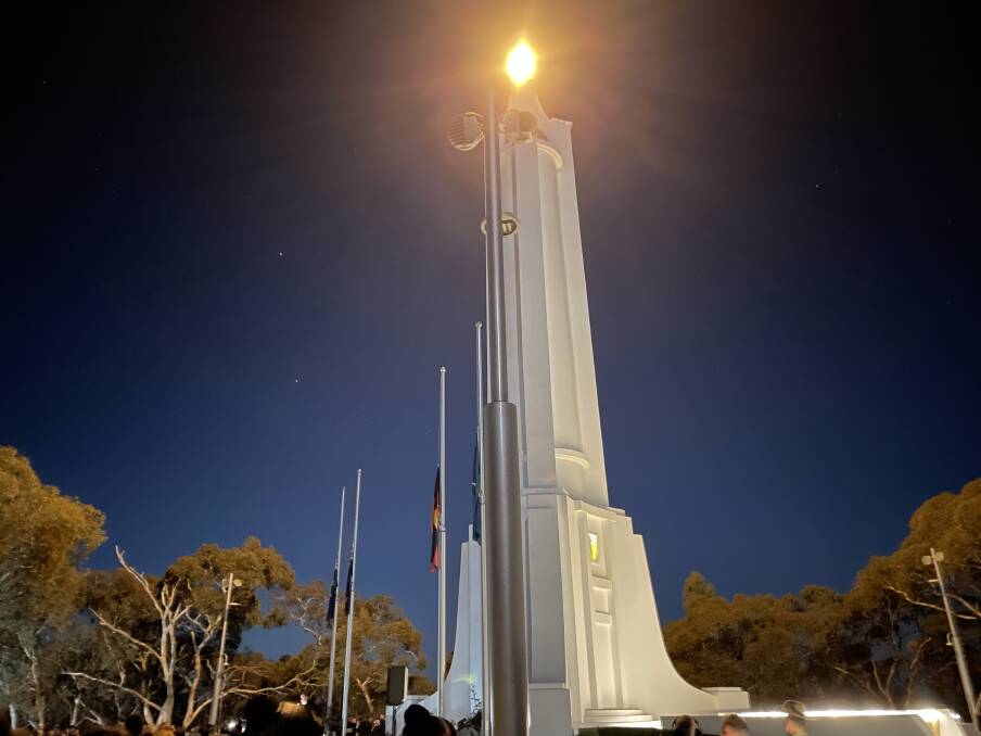 The Albury War Memorial beams with light to mark the city's 2024 Anzac Day dawn service. Picture by Beau Greenway