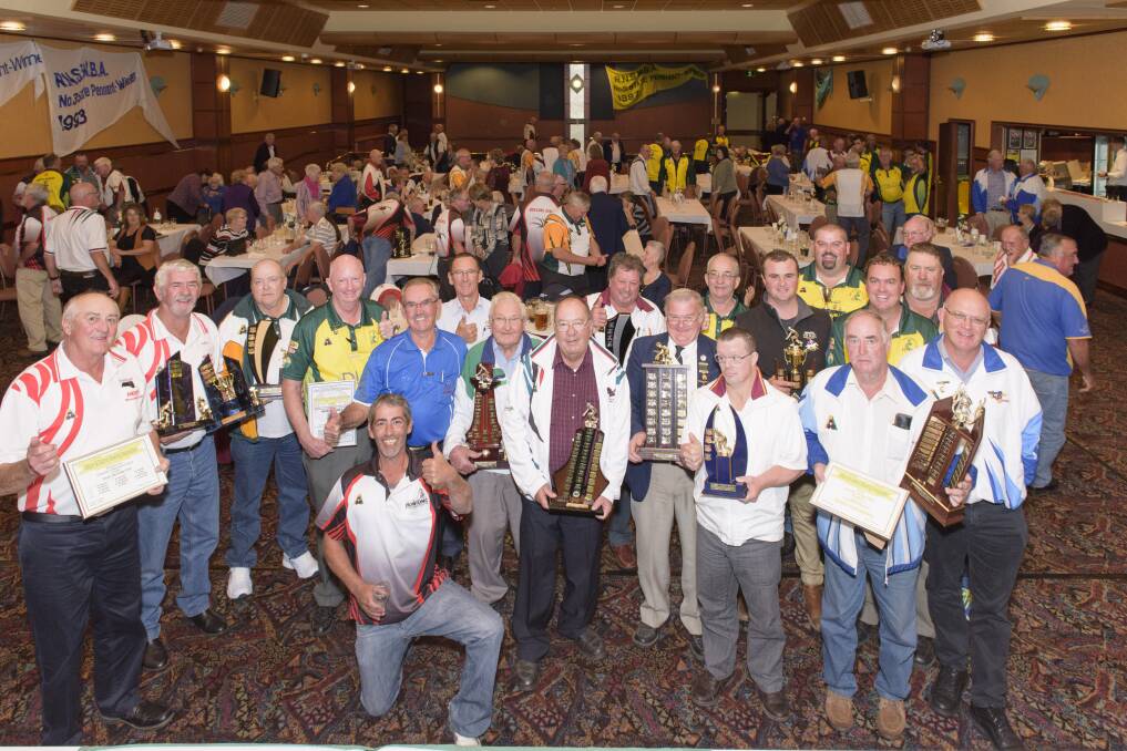 EXCELLENCE: A number of the district bowls awards winners show off their silverware after the Bowler of the Year presentations at the Commercial Club on Sunday. Pictures: SIMON BAYLISS