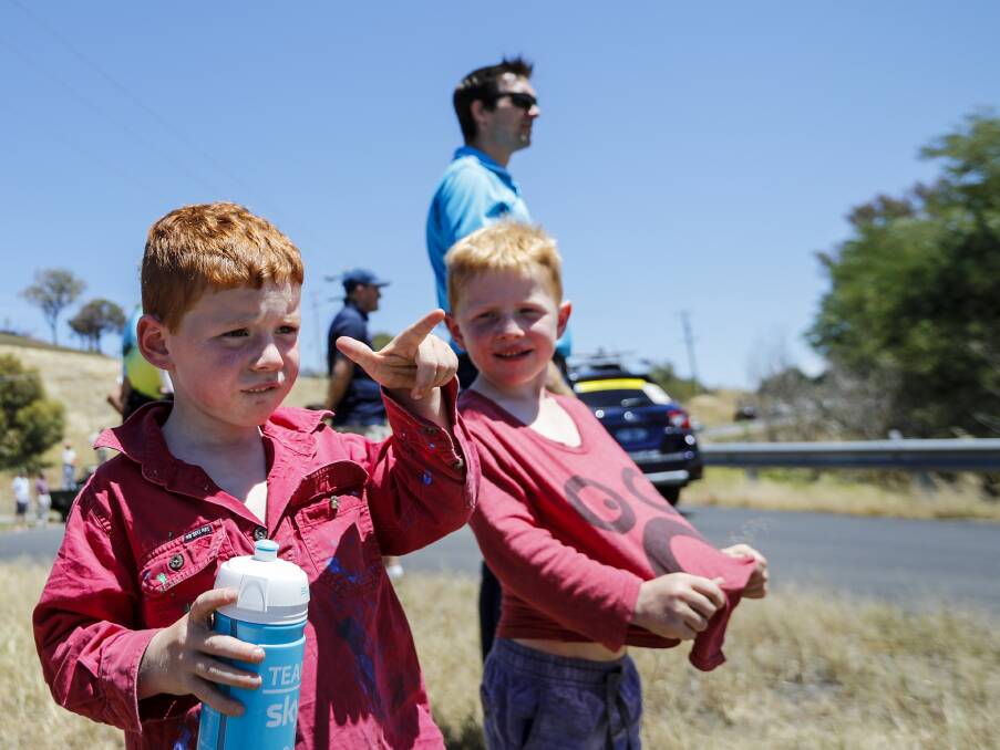 BIG DAY OUT: Oliver and Hamish Colclough, both four, from Mitta Valley, with a bottle thrown by Team Sky as the tour passed by the Sandy Creek football ground. 