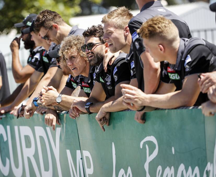BLACK AND WHITE: New Collingwood 
recruit Chris Mayne preparing to sign 
autographs with Alex Fasolo, Jordan 
De Goey and Adam Treloar during 
the Magpies' visit to Wangaratta. 
Picture: JAMES WILTSHIRE