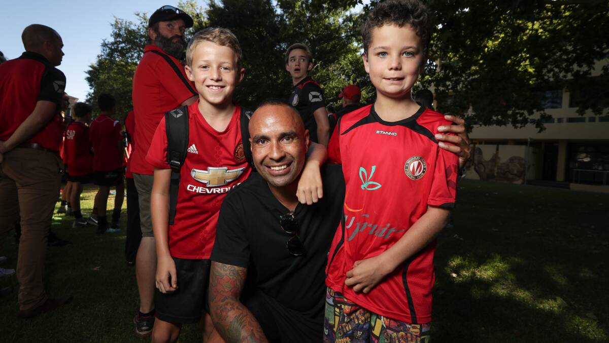 HAPPY TO HELP: Archie Thompson, with Murray United juniors Flynn O'Neill, 10, and Jake Davys, 9, during the club's season launch at the weekend. Picture: JAMES WILTSHIRE