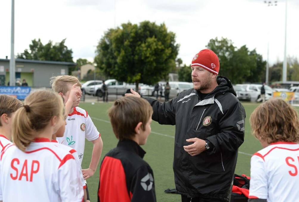 WORTHWHILE DAY: Murray United junior coach Ed Waslander offers some advice to his players during the recent SAP gala day in Melbourne. Picture: FFV