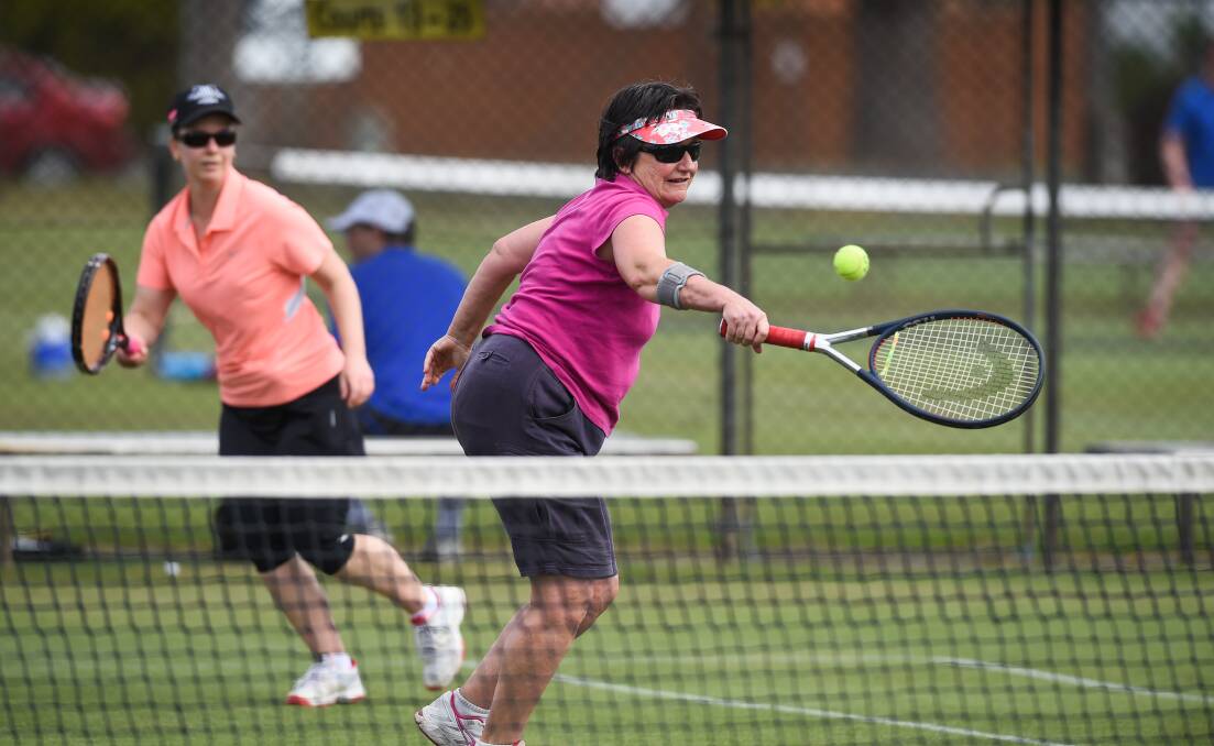 ON THE NET: Trish Baldwin and Jackie Rooke (behind) in action during weekend pennant at the Albury grass courts. Picture: MARK JESSER
