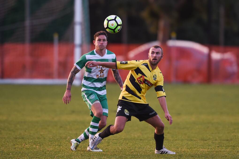 CLOSE WATCH: Cobram's Tyler Seabrook keeps his eye on the ball as Albury United's Sam Mason approaches. Picture: MARK JESSER
