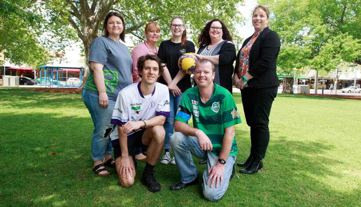 WELL RECEIVED: Melrose soccer player Liam Mackay and Albury United representative Alan Taylor join with Bree Cross (Headspace Albury-Wodonga), Tam Quinn (YES Unlimited), Amy Allitt-Maksymow (YES Unlimited), Bethany Seidel (Centacare south west NSW) and Sarah Carter (Mind Australia) following the huge success of AWFA's mental health round this season. Picture: SIMON BAYLISS