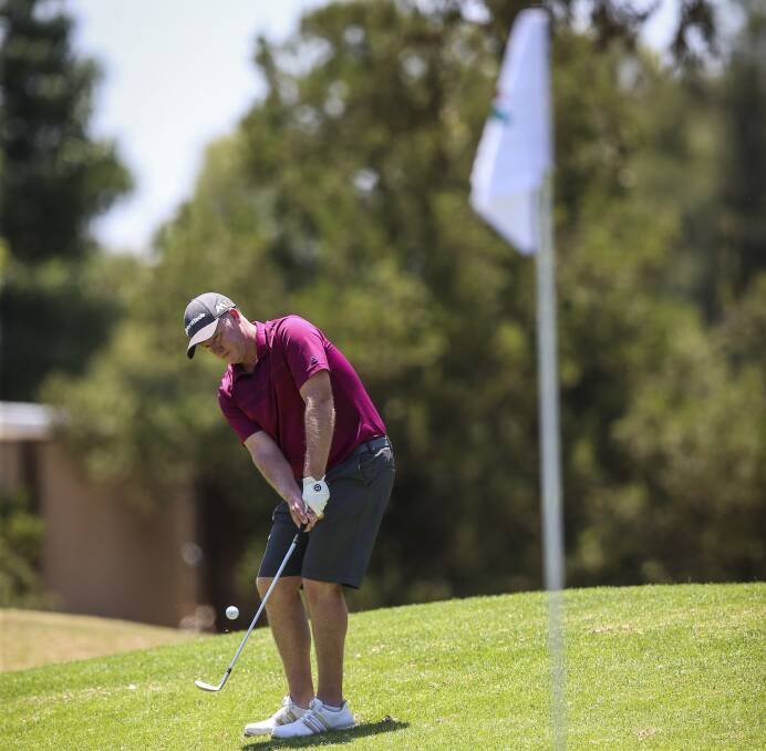GOOD TOUCH: Hometown hero Marcus Fraser chips on from off the green during his annual Ambrose at Corowa Golf Club on Saturday.