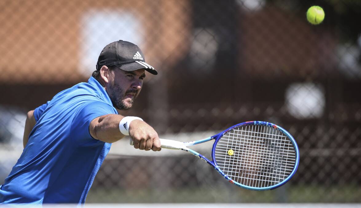CRACKING SHOT: Malcolm Lieschke keeps the ball in play during Saturday's pennant semi-finals at the Albury grass courts. Picture: JAMES WILTSHIRE